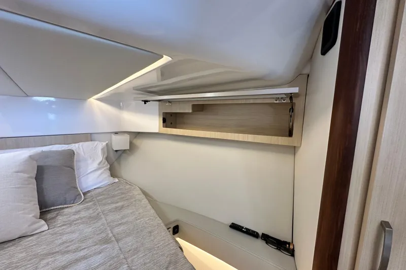 Slide: The Image of Luxurious interior of 2023 Regal 36 Grande Coupe with modern bedding and storage. - 20