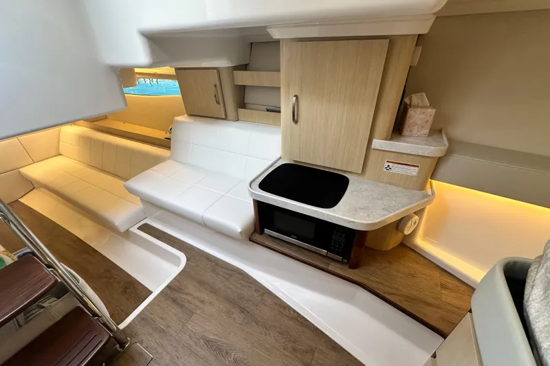 Slide: The Image of Interior of 2023 Regal 36 Grande Coupe with modern kitchen and seating area. - 21