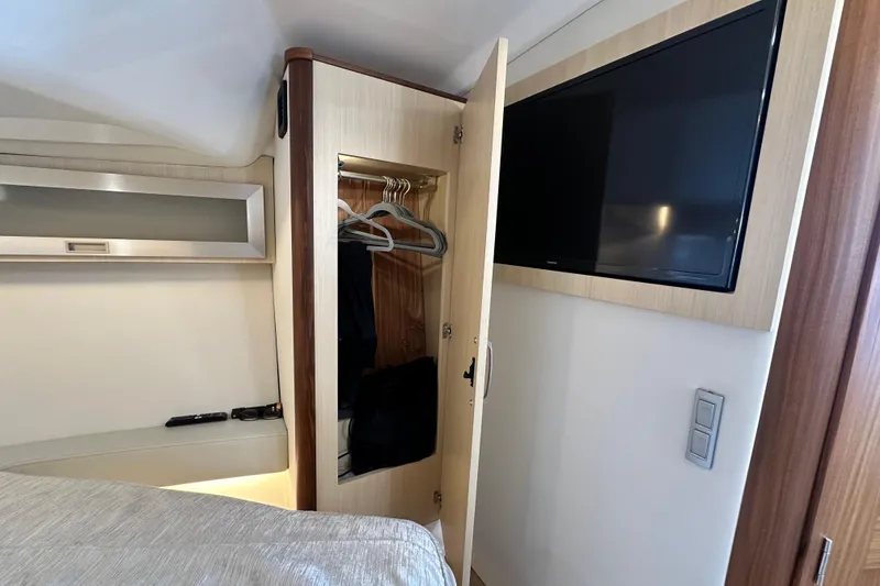 Slide: The Image of 2023 Regal 36 Grande Coupe interior with TV, closet, and modern design. - 25