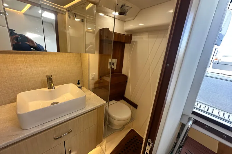 Slide: The Image of 2023 Regal 36 Grande Coupe bathroom with modern sink and wooden accents. - 26