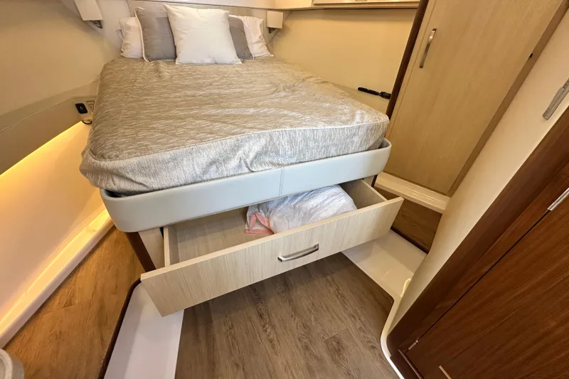 Slide: The Image of 2023 Regal 36 Grande Coupe bedroom with storage drawer under bed. - 28