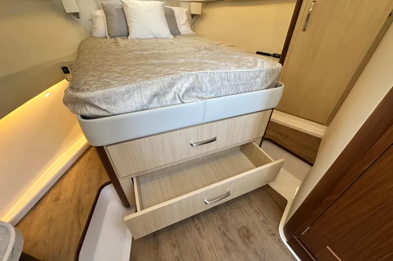 Slide: The Image of 2023 Regal 36 Grande Coupe interior with bed and open storage drawers. - 29