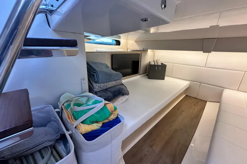 Slide: The Image of Luxurious interior of 2023 Regal 36 Grande Coupe yacht with cozy seating and storage. - 31