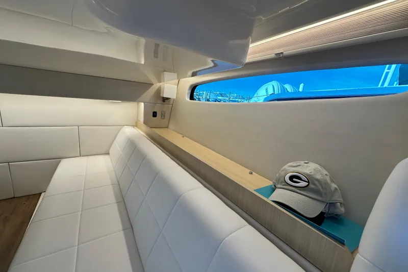 Slide: The Image of Luxurious interior of 2023 Regal 36 Grande Coupe with white seating and scenic window view. - 32