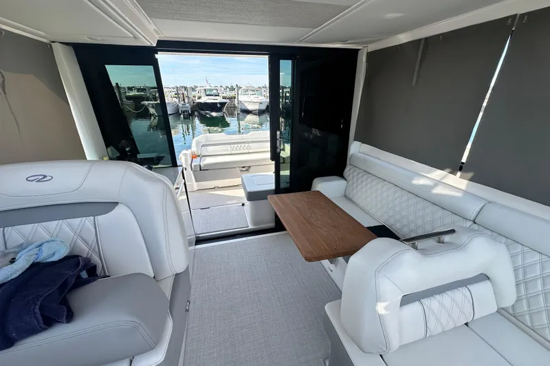 Slide: The Image of Interior of 2023 Regal 36 Grande Coupe yacht with elegant seating and table. - 33
