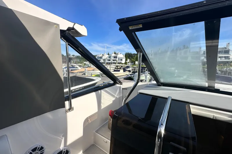 Slide: The Image of 2023 Regal 36 Grande Coupe yacht interior with marina view through windows. - 34