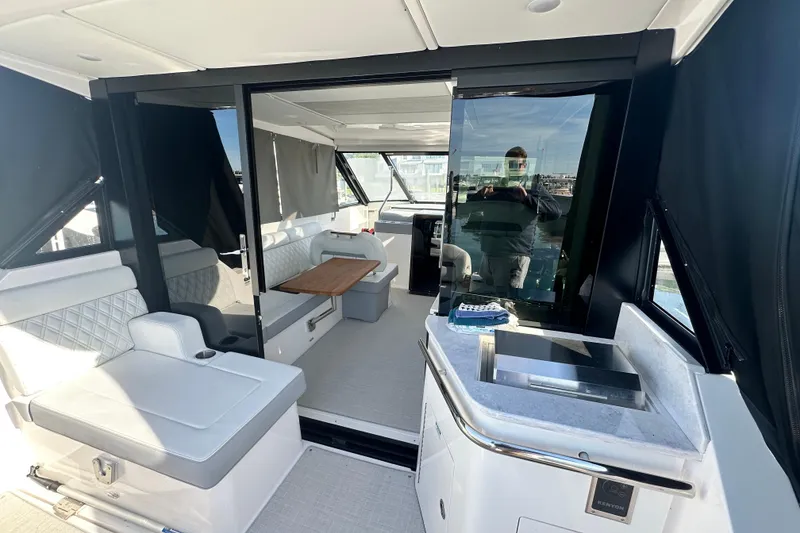 Slide: The Image of 2023 Regal 36 Grande Coupe interior with modern seating and kitchenette. - 4