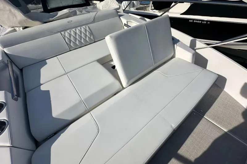 Slide: The Image of 2023 Regal 36 Grande Coupe boat interior with white cushioned seating. - 40
