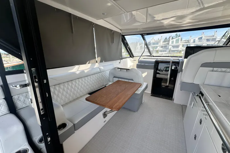 Slide: The Image of Interior of 2023 Regal 36 Grande Coupe yacht with elegant seating and wooden table. - 44