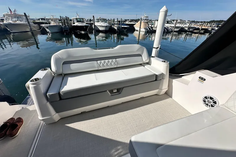Slide: The Image of 2023 Regal 36 Grande Coupe yacht interior with luxurious seating at marina. - 45
