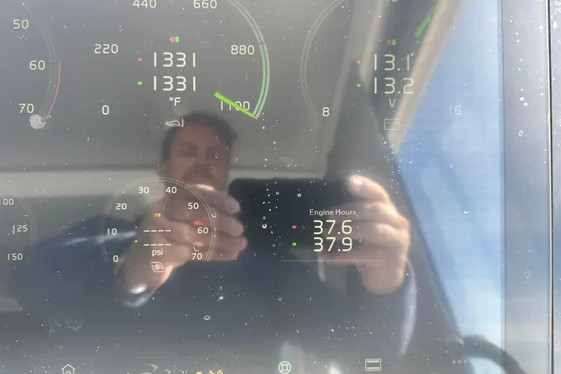 Slide: The Image of Reflection on Regal 36 Grande Coupe 2023 dashboard displaying engine hours and gauges. - 49