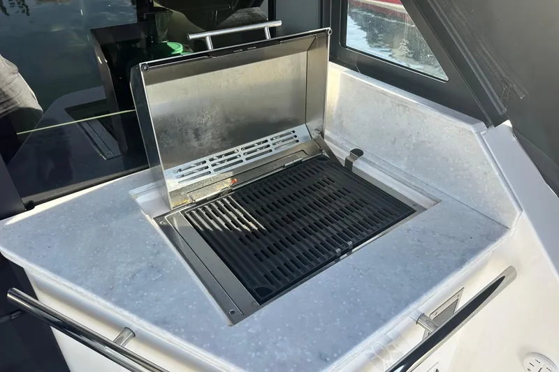 Slide: The Image of Outdoor grill on 2023 Regal 36 Grande Coupe yacht, featuring sleek countertop design. - 5