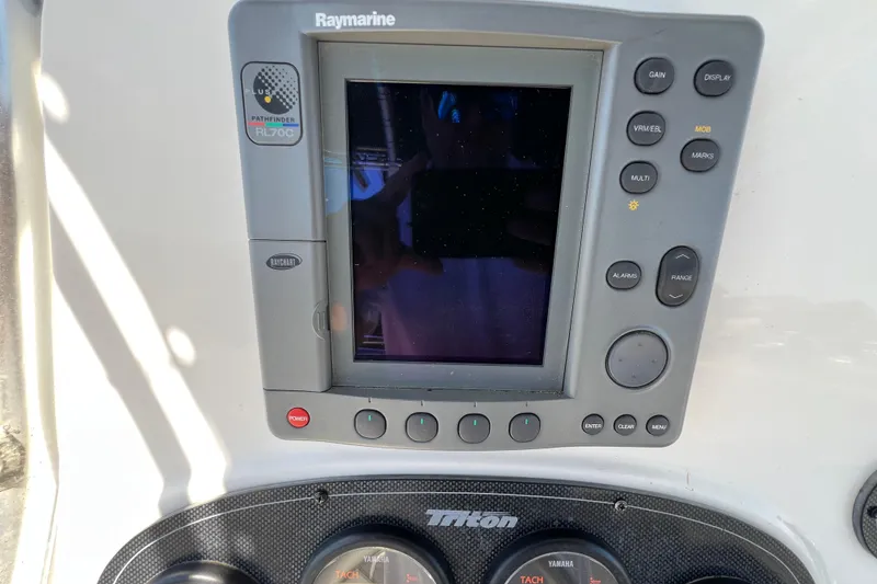 Slide: The Image of Control panel of a 2003 Triton 2690 CC boat with Raymarine display. - 13