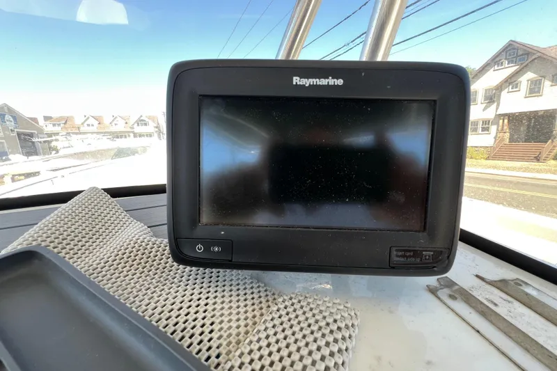 Slide: The Image of Raymarine display on 2003 Triton 2690 CC boat, with houses visible through window. - 14
