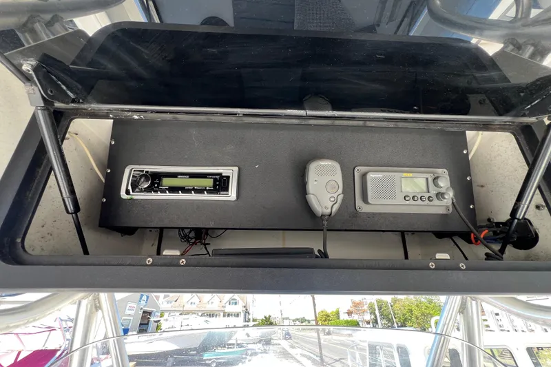 Slide: The Image of 2003 Triton 2690 CC boat dashboard with radio and communication equipment. - 15