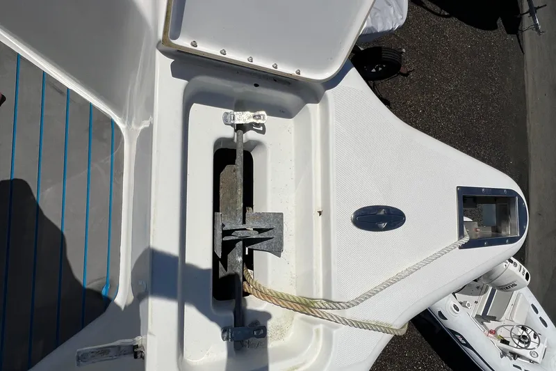 Slide: The Image of Anchor compartment of 2003 Triton 2690 CC boat with visible rope and fittings. - 23