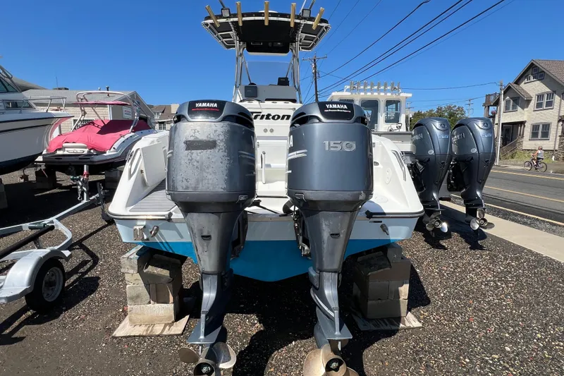 Slide: The Image of 2003 Triton 2690 CC boat with dual Yamaha 150 outboard motors on display. - 5
