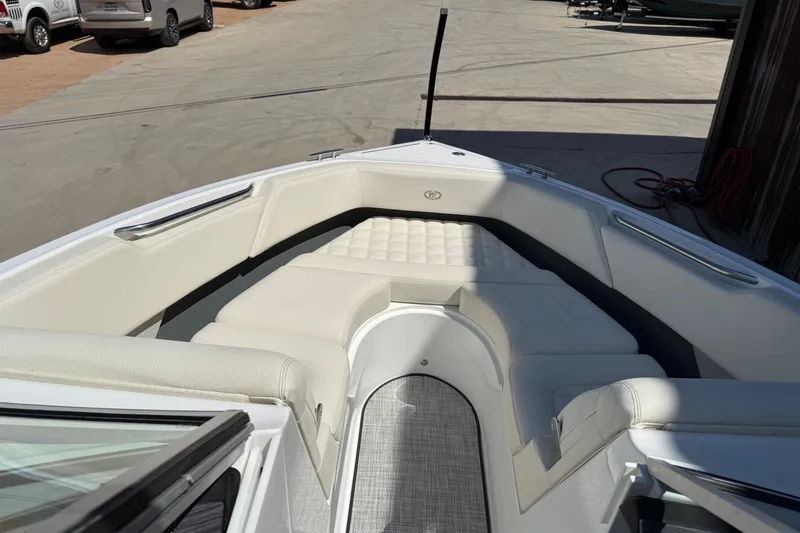Slide: The Image of 2019 Cobalt R3 boat interior with white cushioned seating and sleek design. - 10