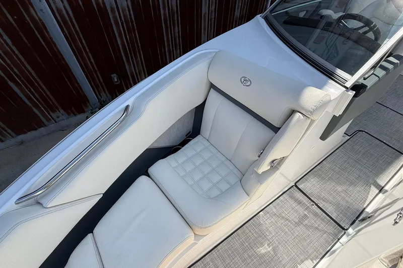 Slide: The Image of 2019 Cobalt R3 boat interior with white cushioned seating and sleek design. - 11