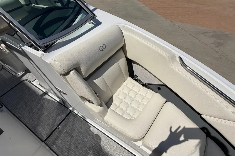 Slide: The Image of 2019 Cobalt R3 boat interior with white cushioned seating and sleek design. - 12