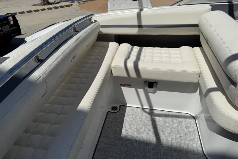 Slide: The Image of 2019 Cobalt R3 boat interior with white cushioned seating and sleek design. - 16