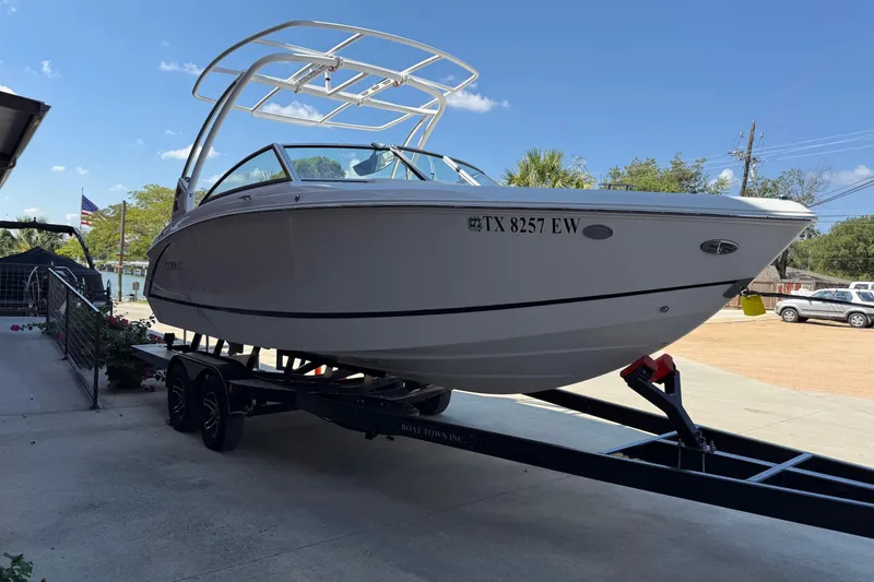 Slide: The Image of 2019 Cobalt R3 boat on trailer, parked outdoors under clear blue sky. - 3