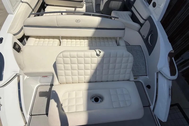 Slide: The Image of 2019 Cobalt R3 boat interior with white cushioned seating and sleek design. - 5