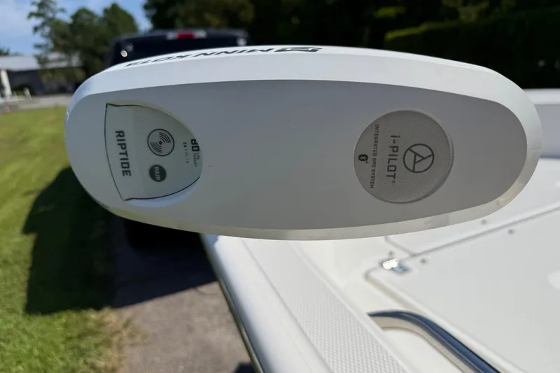 Slide: The Image of 2022 Boston Whaler 170 Montauk boat with open storage, parked on grass beside a truck. - 10