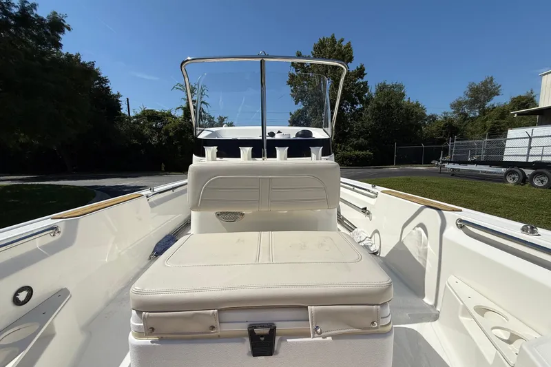 Slide: The Image of 2022 Boston Whaler 170 Montauk boat interior with open storage compartment and steering wheel. - 11