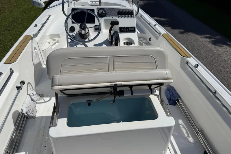 Slide: The Image of 2022 Boston Whaler 170 Montauk boat on trailer, parked on a sunny street. - 12