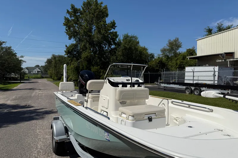 Slide: The Image of 2022 Boston Whaler 170 Montauk boat on a sunny day, parked on grass. - 13