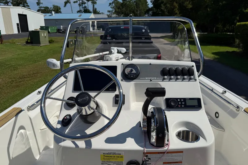 Slide: The Image of 2022 Boston Whaler 170 Montauk boat console with steering wheel and controls. - 6