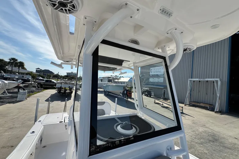 Slide: The Image of 2026 Caymas 24 HB boat interior view at a marina, showcasing modern design features. - 16