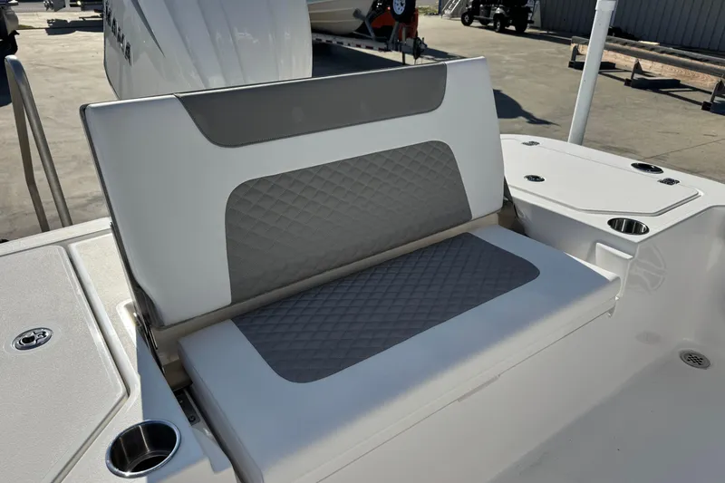 Slide: The Image of 2026 Caymas 24 HB boat seat with gray diamond-patterned upholstery and cup holders. - 21