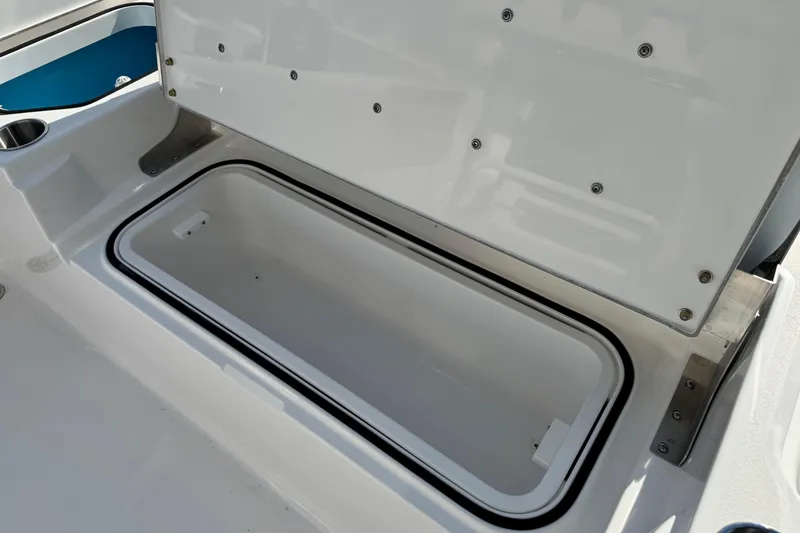 Slide: The Image of Open storage compartment on 2026 Caymas 24 HB boat, showcasing interior space. - 24