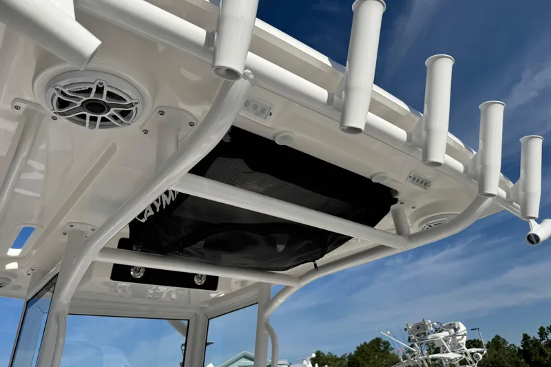 Slide: The Image of 2026 Caymas 24 HB boat with rod holders and speakers under a clear blue sky. - 26