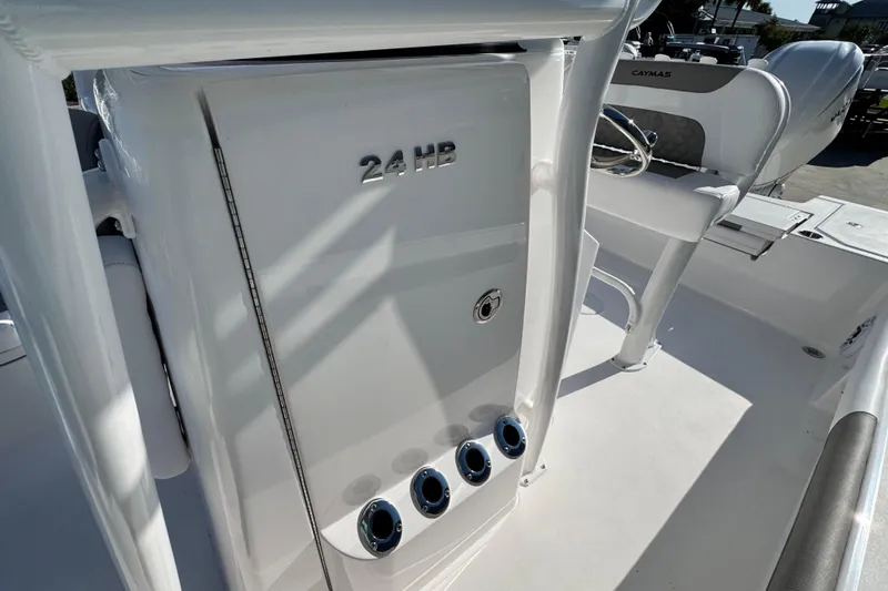 Slide: The Image of 2026 Caymas 24 HB boat interior with seating and console details. - 27
