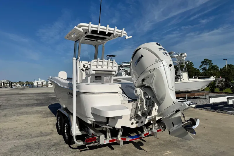 Slide: The Image of 2026 Caymas 24 HB boat with Yamaha outboard motor on trailer, parked outdoors. - 4