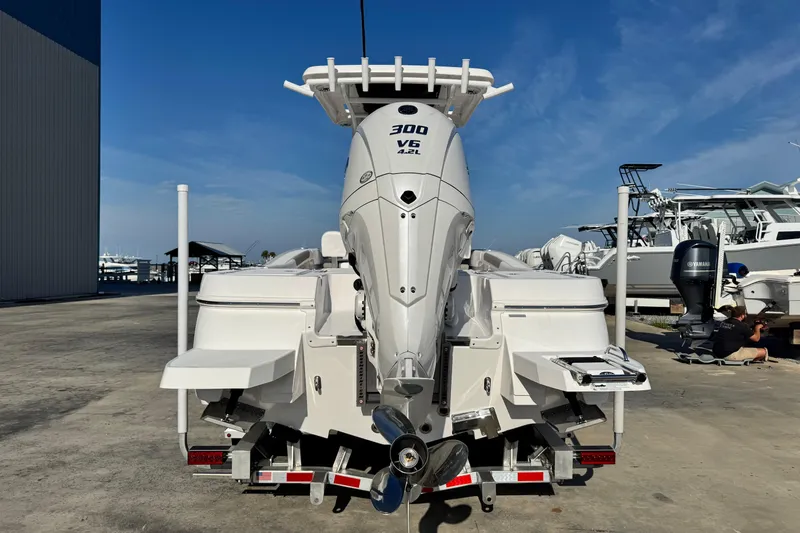 Slide: The Image of 2026 Caymas 24 HB boat with powerful 300 V6 engine, docked outdoors. - 5