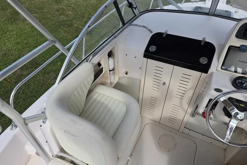Slide: The Image of 2007 Grady-White Seafarer 228 boat interior with helm, seat, and controls. - 11