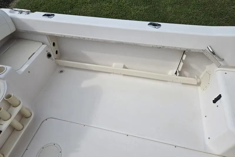 Slide: The Image of 2007 Grady-White Seafarer 228 boat interior, featuring spacious deck and rod holders. - 13