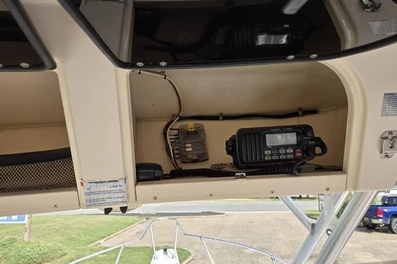 Slide: The Image of 2007 Grady-White Seafarer 228 boat electronics compartment with radio equipment. - 16