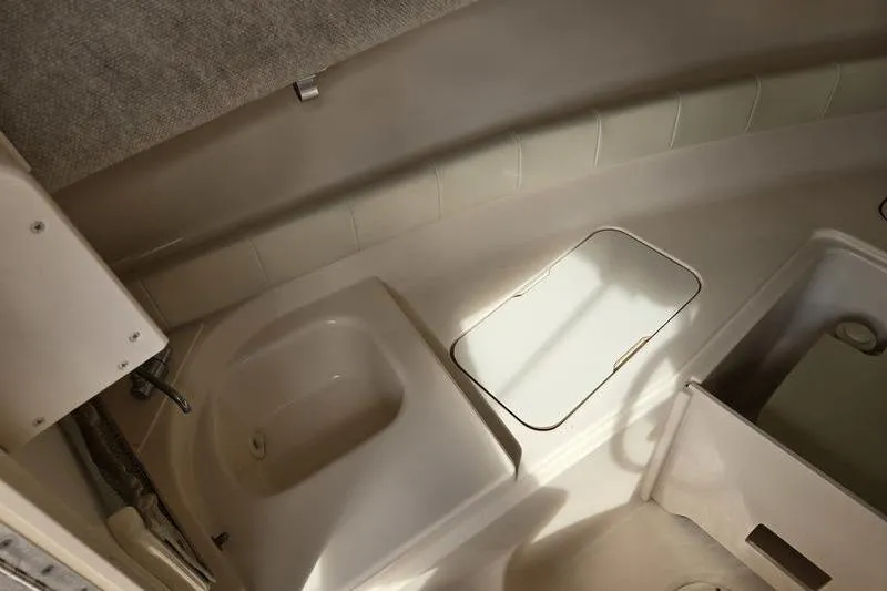 Slide: The Image of 2007 Grady-White Seafarer 228 boat interior, featuring a compact sink and storage area. - 20