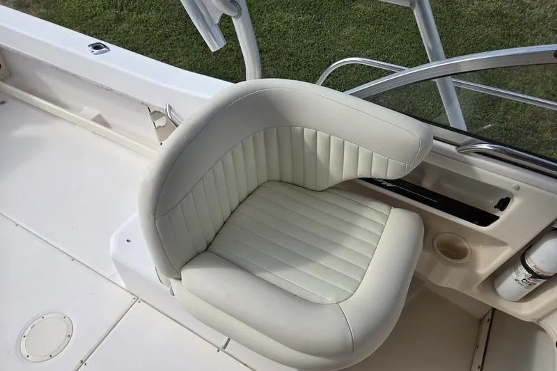 Slide: The Image of 2007 Grady-White Seafarer 228 boat seat, white upholstery, near helm station. - 21