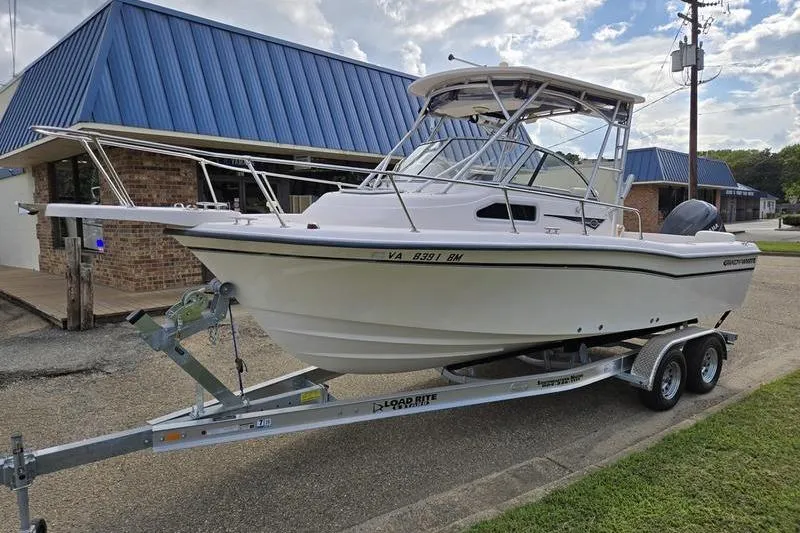 Slide: The Image of 2007 Grady-White Seafarer 228 boat on trailer, parked near a building. - 3