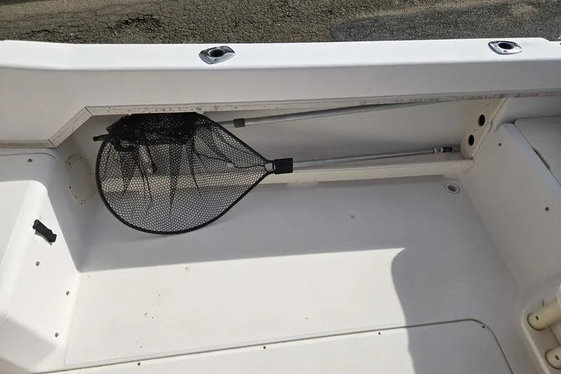 Slide: The Image of 2007 Grady-White Seafarer 228 boat interior with fishing net storage. - 4