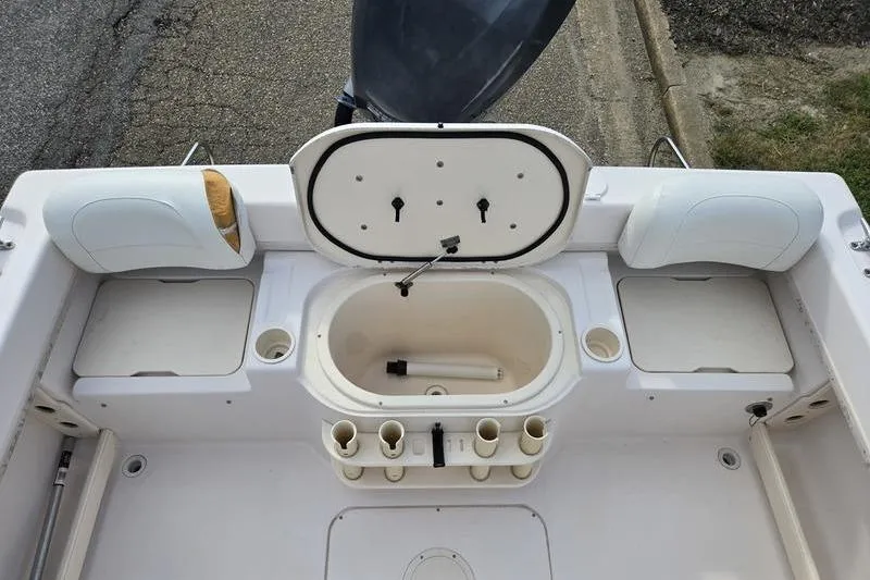Slide: The Image of 2007 Grady-White Seafarer 228 boat interior with open storage compartments and rod holders. - 9