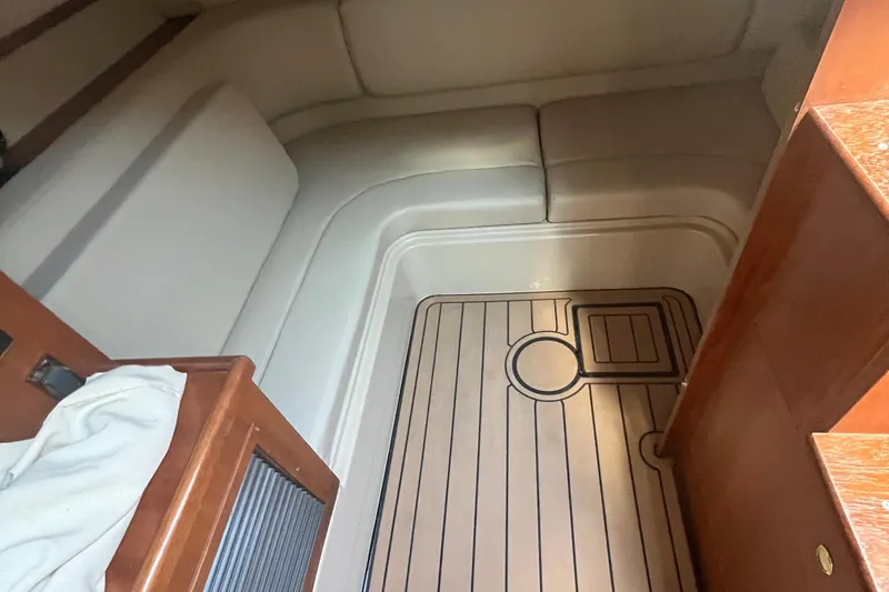 Slide: The Image of 2001 Cruisers Yachts 3470 Express cabin interior with wood flooring and cushioned seating. - 10