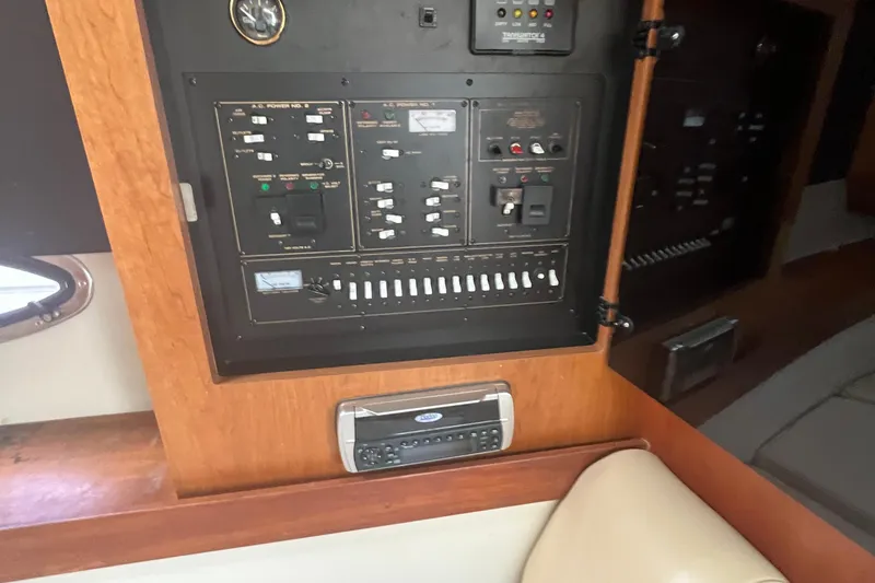 Slide: The Image of Control panel inside 2001 Cruisers Yachts 3470 Express, featuring switches and gauges. - 15
