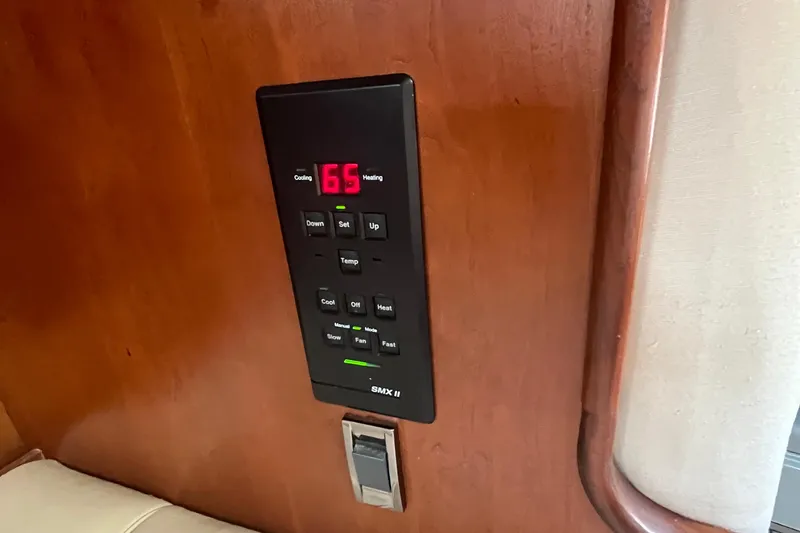 Slide: The Image of Thermostat control panel on 2001 Cruisers Yachts 3470 Express, displaying temperature settings. - 16